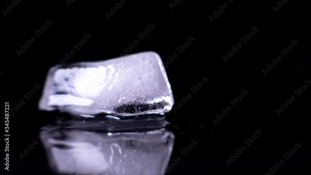 Ice cube melting - Black background - Time Lapse Ice cube melting - Black background - Time Lapse