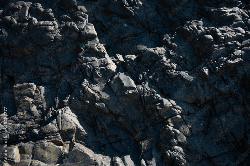 Black rock, stone, textured. Background for design. Hard light. Black rock, stone, textured. Background for design. Hard light.