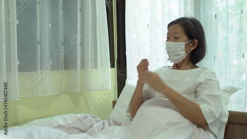Senior asian woman is wearing face mask to prevent covid-19 or coronavirus infection as a social distancing guideline during outbreak. new normal lifestyle concept 