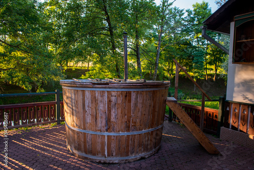 rustic wooden tub or swimming pool used outside, especially in winter © florinfaur