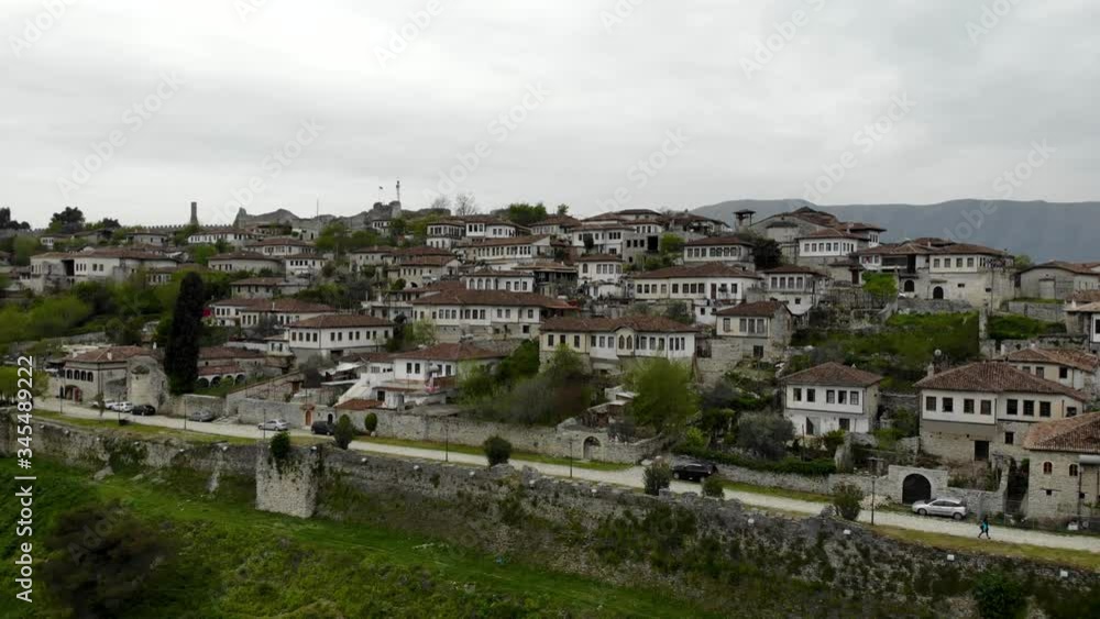 Beautiful houses with white facades, stone walls and thousand windows on citadel neighborhood of historical Berat city in Albania Beautiful houses with white facades, stone walls and thousand windows on citadel neighborhood of historical Berat city in Albania