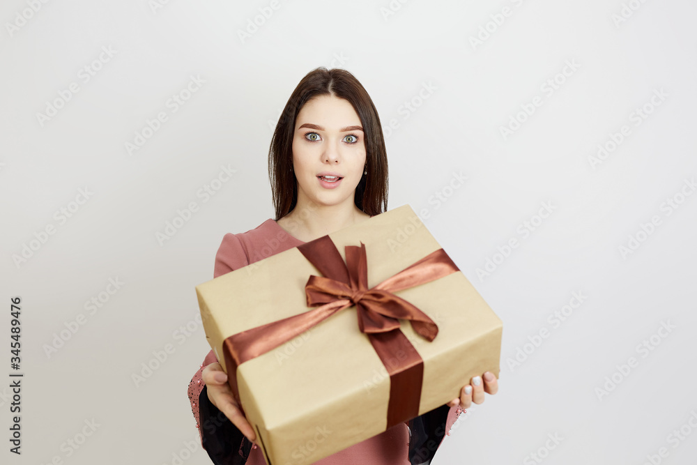 Girl with gift boxes on the eve of the holiday. Blank for advertising, a man receives gifts on a white background. Girl with gift boxes on the eve of the holiday. Blank for advertising, a man receives gifts on a white background.