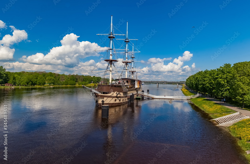 Sailboat on the river in the city against the blue sky in summer Sailboat on the river in the city against the blue sky in summer