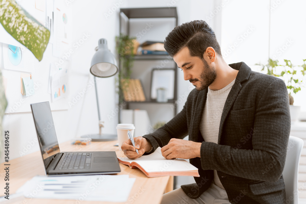 man working on a laptop at home. man working on a laptop at home.