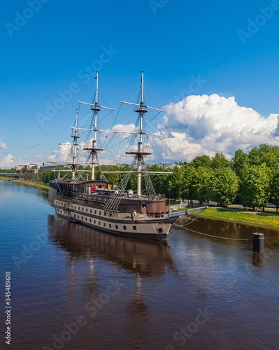 Sailboat on the river in the city against the blue sky in summer