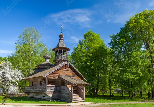 Wooden Church in the forest in summer against the sky