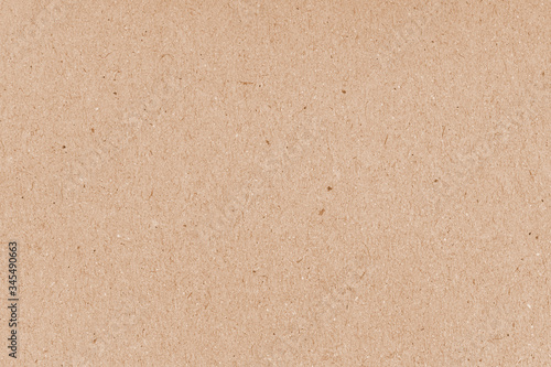 Cardboard grunge recycled craft paper texture with fiber and grain. Brown grainy corrugated cardboard surface. Beige carton plain surface. Grain paper texture. Paper box for packing