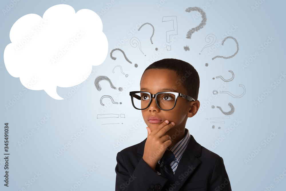 concept of confusion, inspiration and solution- pensive little african american boy in business suit and in glasses with empty speech bubble and many questions concept of confusion, inspiration and solution- pensive little african american boy in business suit and in glasses with empty speech bubble and many questions