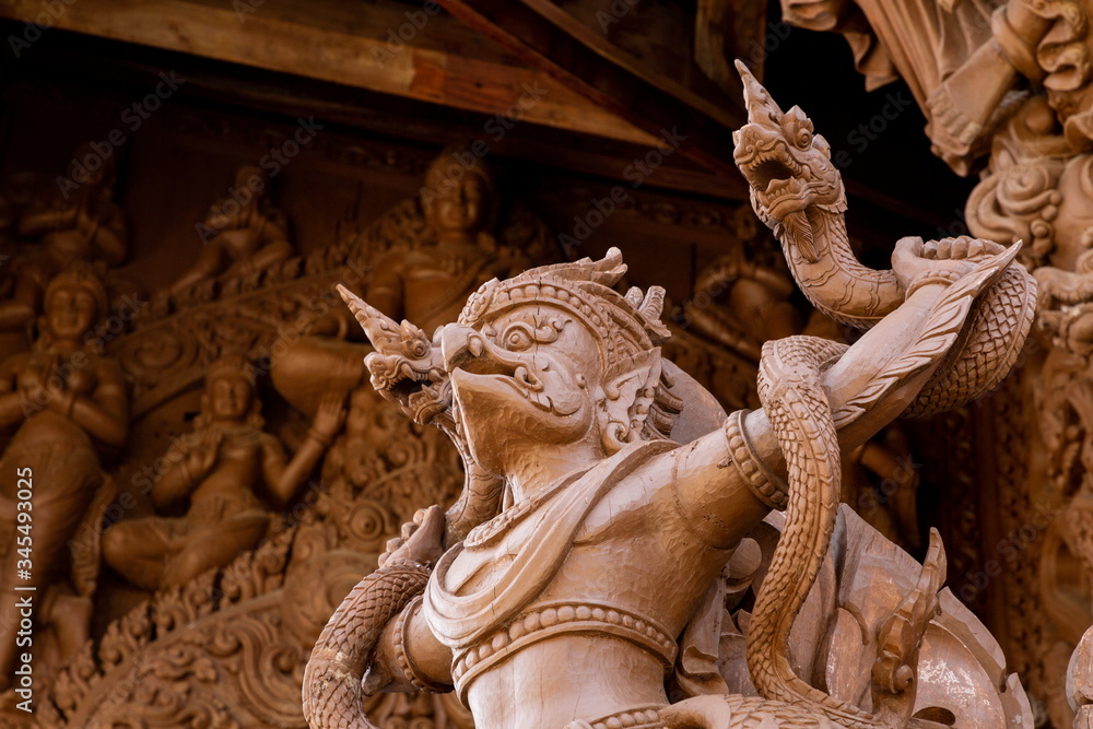Fototapeta premium wooden garuda and naga on temple in Thailand .