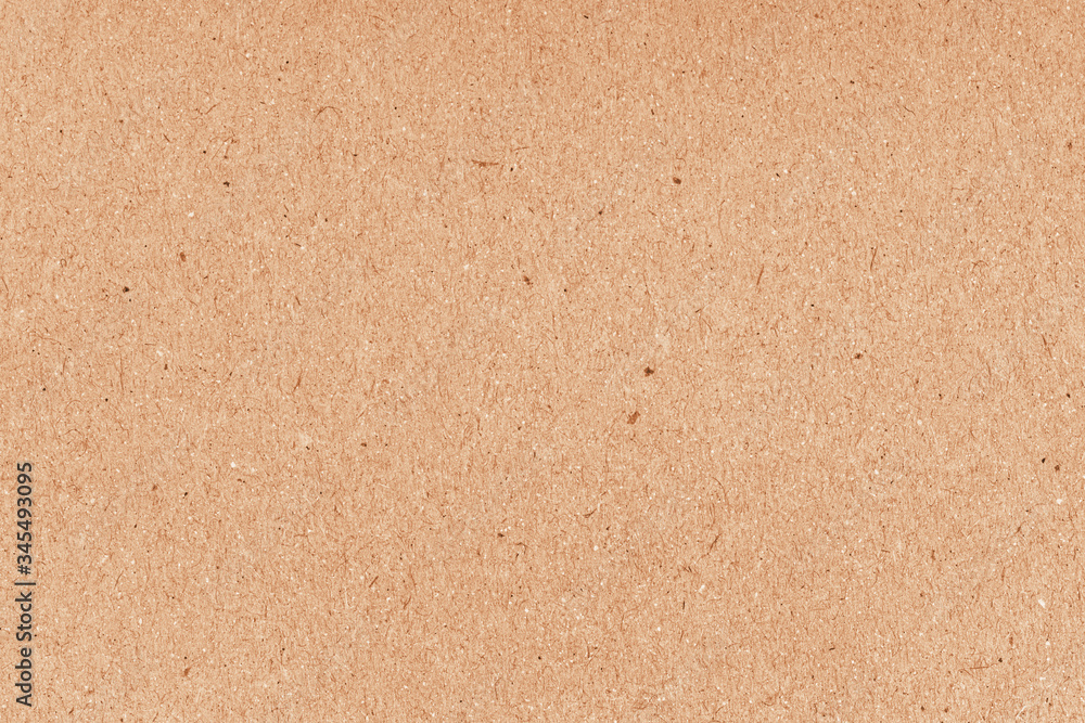 Brown grainy corrugated cardboard surface. Beige carton plain surface. Grain paper texture. Brown grainy corrugated cardboard surface. Beige carton plain surface. Grain paper texture.