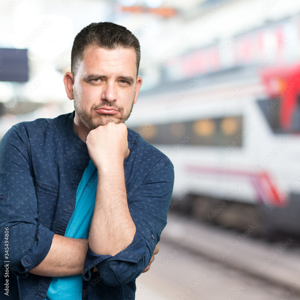 Young man wearing a blue outfit. Looking sad. Young man wearing a blue outfit. Looking sad.