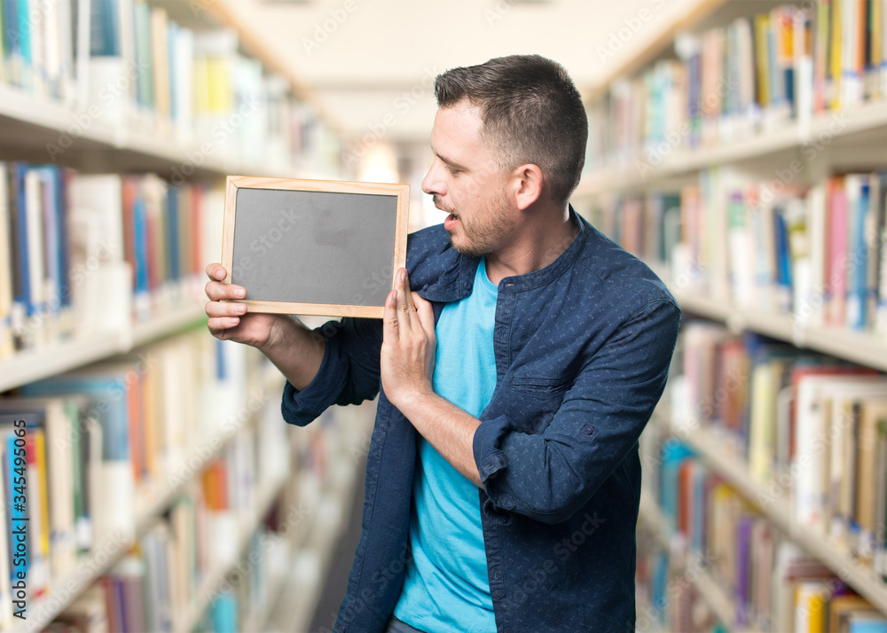 Young man wearing a blue outfit. Looking into board. Young man wearing a blue outfit. Looking into board.