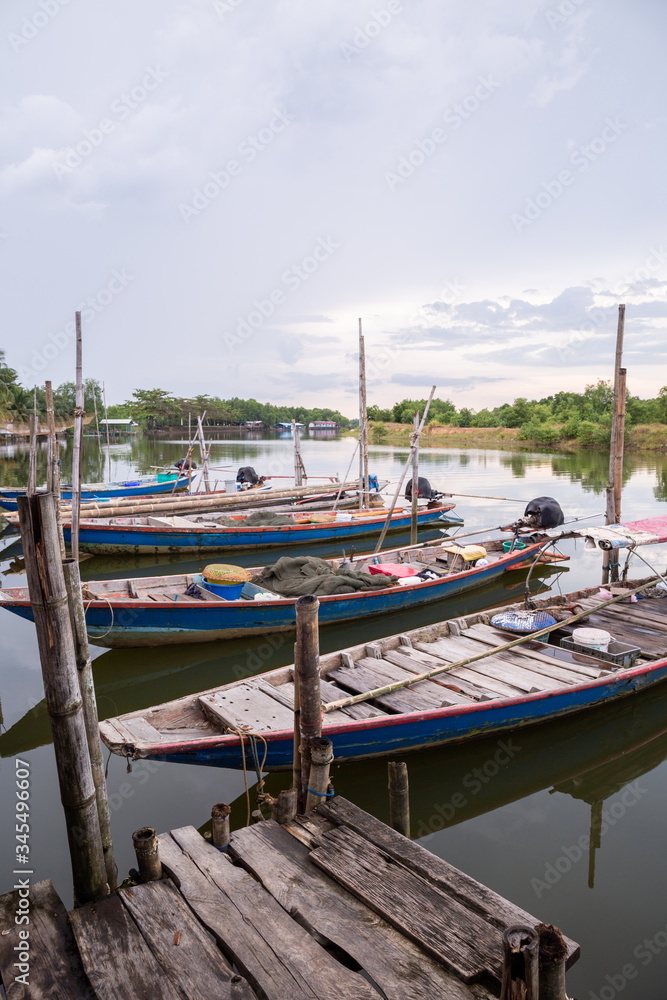 Fototapeta premium fisherman boat on river at countryside wooden port .