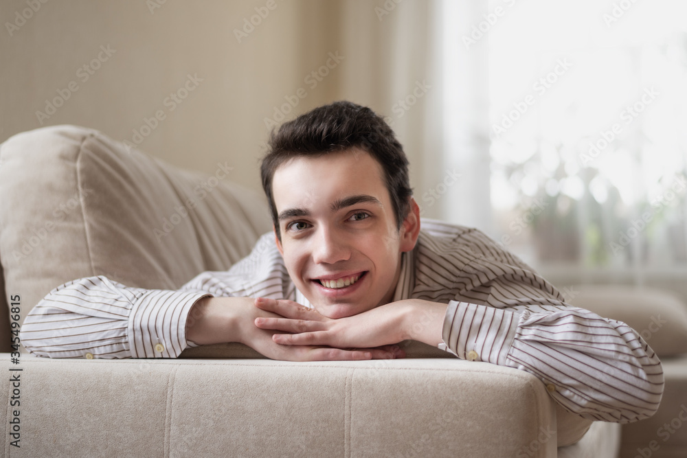 Teenager young man lying on sofa at home Teenager young man lying on sofa at home