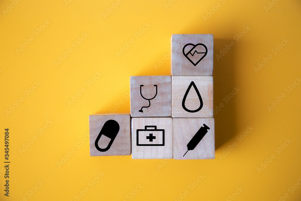 wood cube with a medical symbol angle Flat lay,Concept: Health insurance family covid-2019 epidemic, wood cube with a medical symbol angle Flat lay,Concept: Health insurance family covid-2019 epidemic,