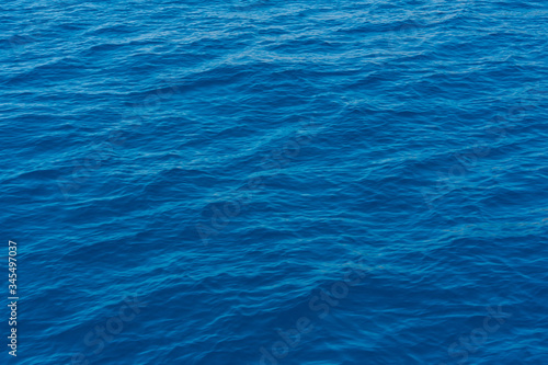 A close up of the deep and pristine blue Mediterranean sea on a sunny day, in Sardinia Italy