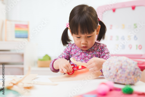 toddler girl making craft for homeschooling