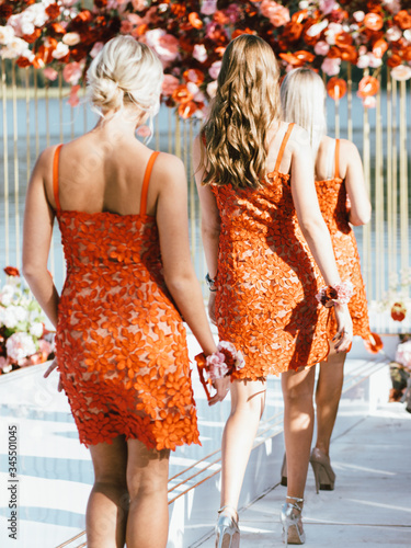 Bridesmaids at the ceremony in red