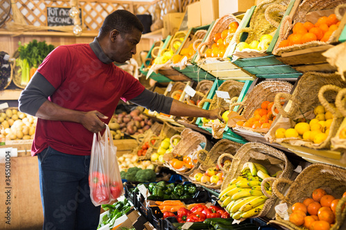 Man looking for vegetables and fruits in greengrocery
