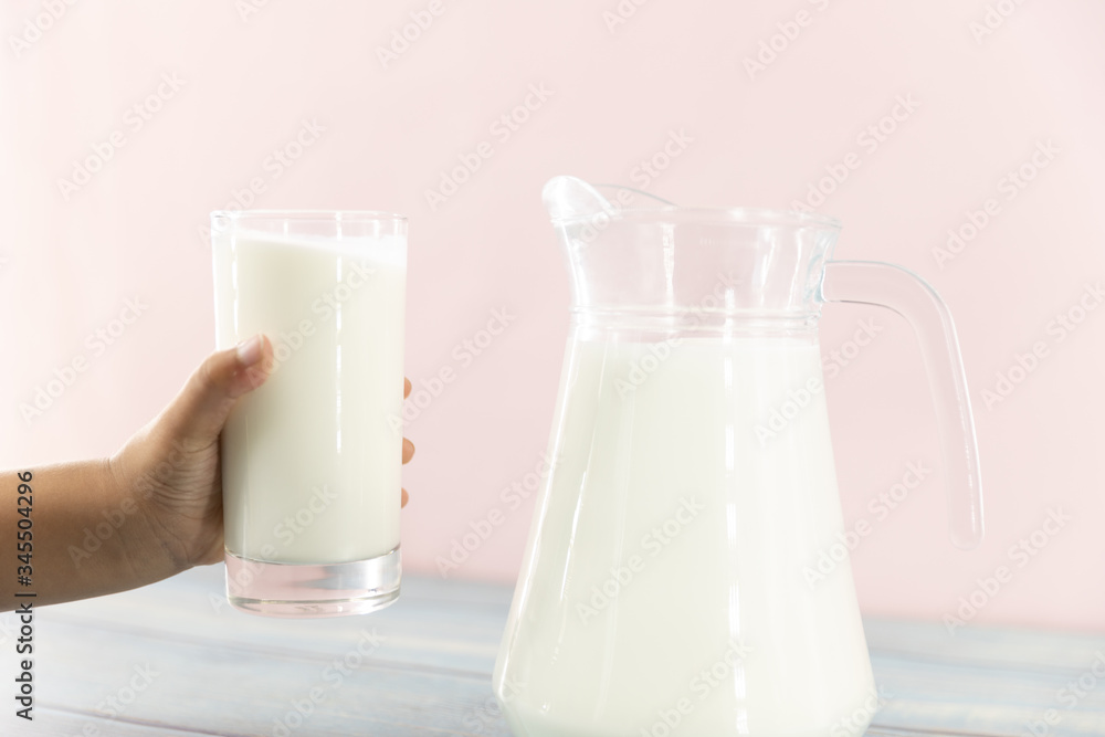 Child hand with a glass of milk. Drink milk for good health concept. Child hand with a glass of milk. Drink milk for good health concept.