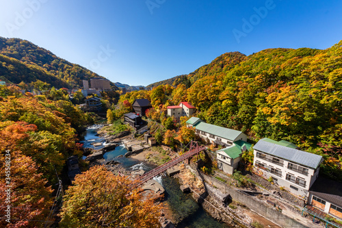 札幌市・定山渓温泉にて定山渓大橋から色とりどりの紅葉に染まる山と豊平川を眺める