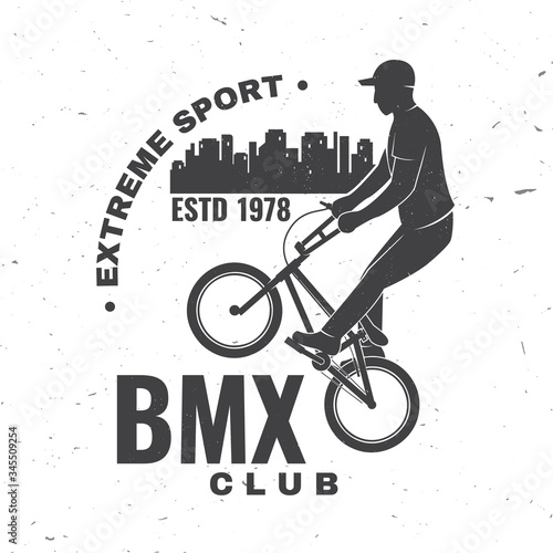 Bmx extreme sport club badge. Vector. Concept for shirt, logo, print, stamp, tee with man ride on a sport bicycle. Vintage typography design with bmx cyclist and night city silhouette.
