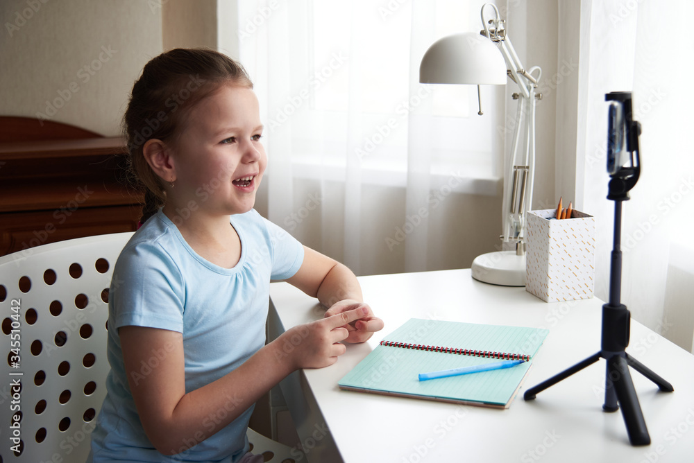 a beautiful cute little girl blogger records videos on her smartphone for her subscribers. a beautiful cute little girl blogger records videos on her smartphone for her subscribers.