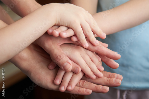 People putting hands together, closeup. Unity concept
