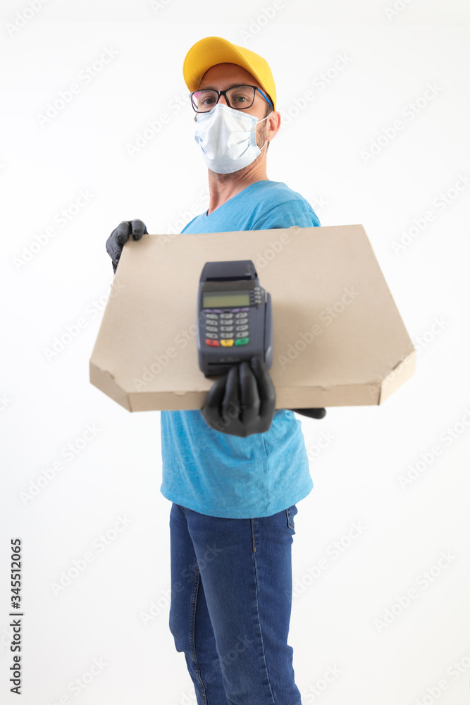 Delivery guy with protective mask holding pizza box and POS for contactless payment. Delivery guy with protective mask holding pizza box and POS for contactless payment.