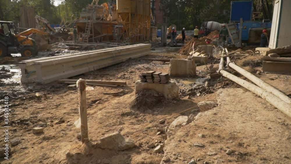 male builders lay the foundation on a sunny day. discussion of construction work. residential building concept/ male builders lay the foundation on a sunny day. discussion of construction work. residential building concept/