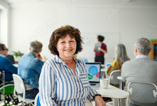 Portrait of senior attending computer and technology education class.