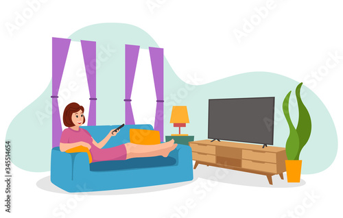 A woman is watching television inside the house during the covid-19 virus pandemic