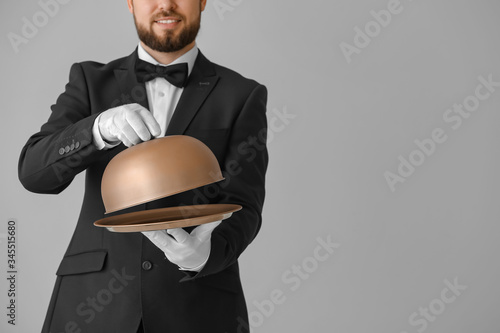 Handsome male waiter with t...