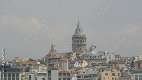 Istanbul, Turkey - June 11, 2019: June 11, 2019: Istanbul view of the Galata Tower from the waterside. Eminonu side is major travel and tourism center in the city photo