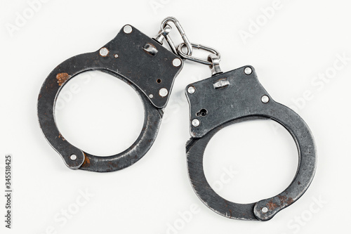 A pair of handcuffs isolated on a white background