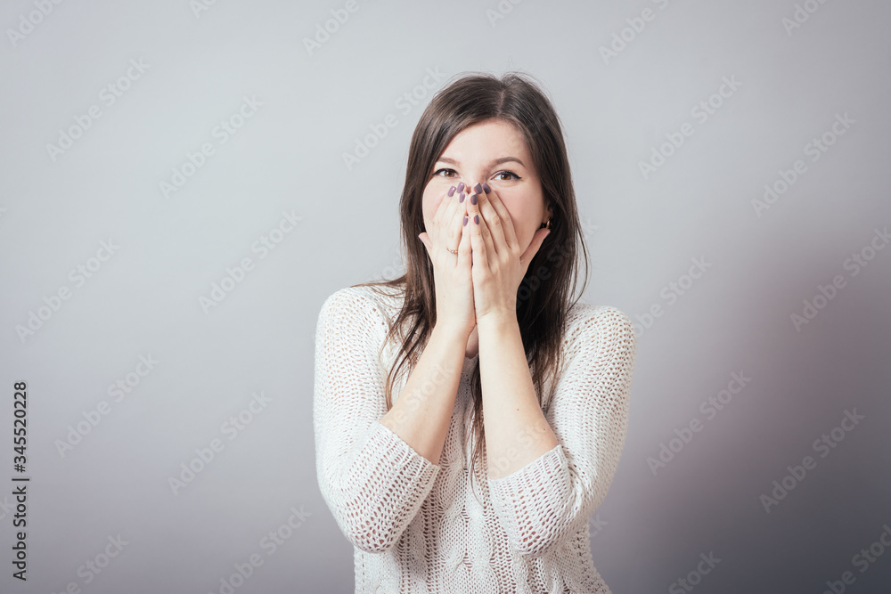 girl covering her mouth with her hands girl covering her mouth with her hands