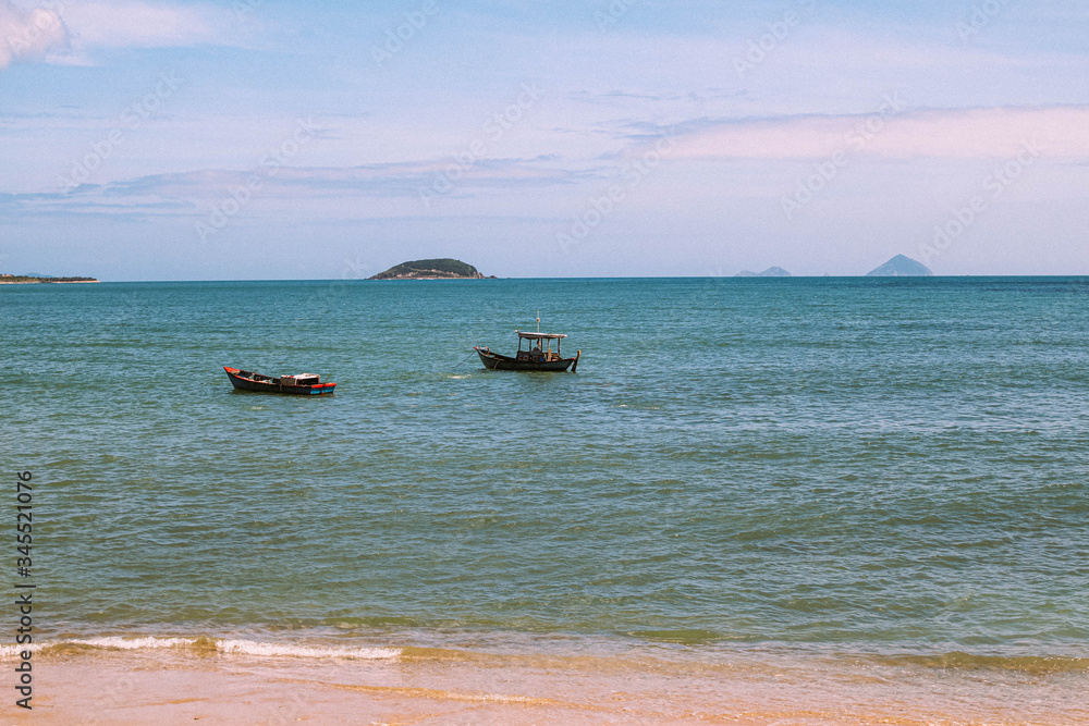 Fishing boats in azure water in Nha Trang, Vietnam. Seascape