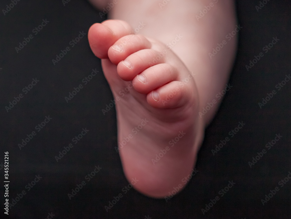 Small boy's foot close up on black background Small boy's foot close up on black background