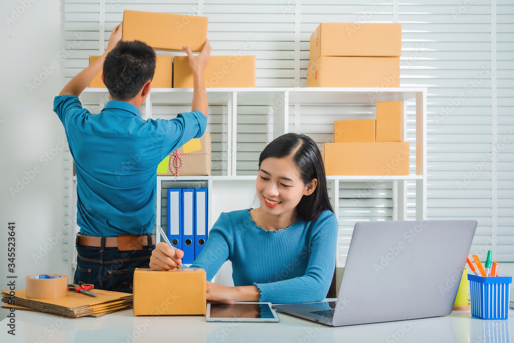 Partnership of SME entrepreneur teamwork of small business work at home family online marketing with packing box prepare for deliverty to customers at warehouse home seller office. Partnership of SME entrepreneur teamwork of small business work at home family online marketing with packing box prepare for deliverty to customers at warehouse home seller office.