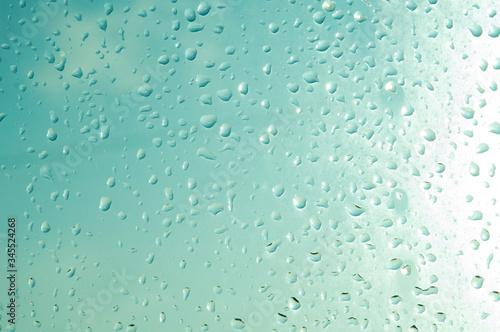 Raindrops or steam shower, on a transparent glass background. Realistic clean drops flow down.