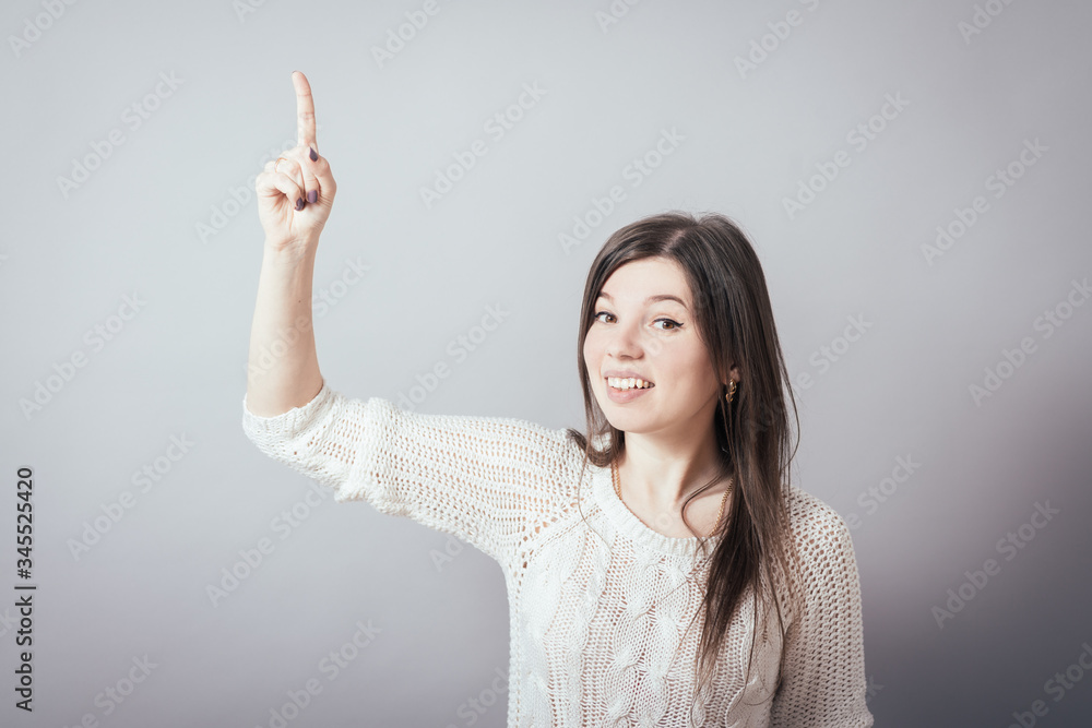 girl shows the index finger up girl shows the index finger up