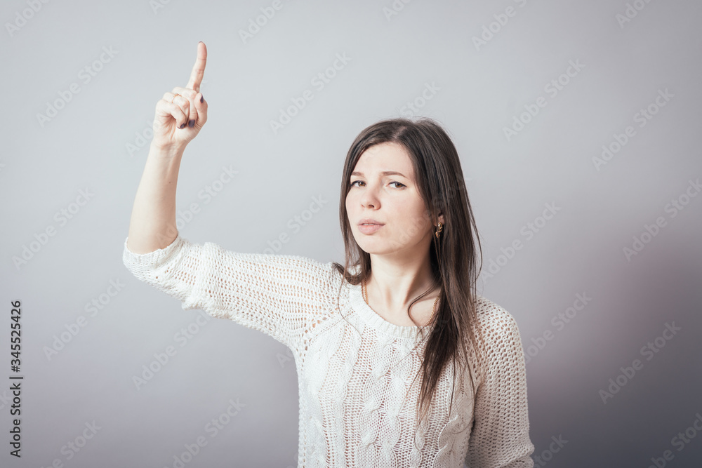girl shows the index finger up girl shows the index finger up