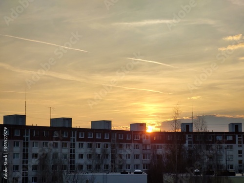 Sunrise and sunset, beautiful clouds over the meadow, hills and buildings in the town. Slovakia