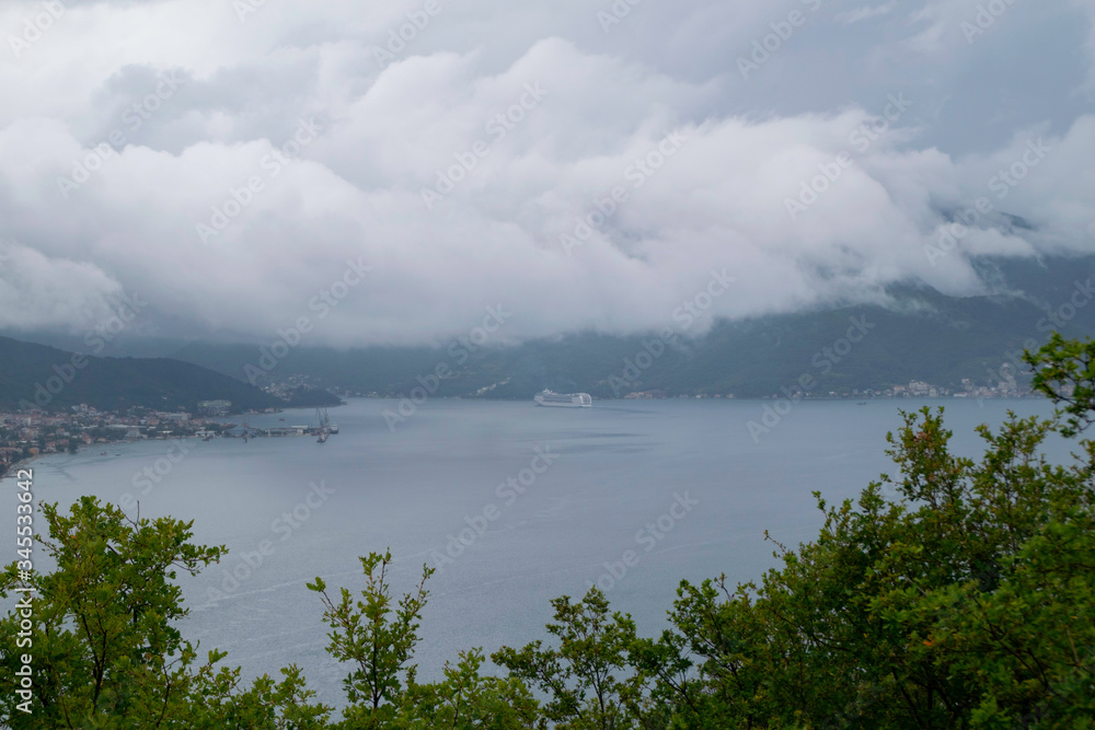 Massive rain clouds lie down on the Bay of Kotor, Adriatic Sea, Montenegro.
