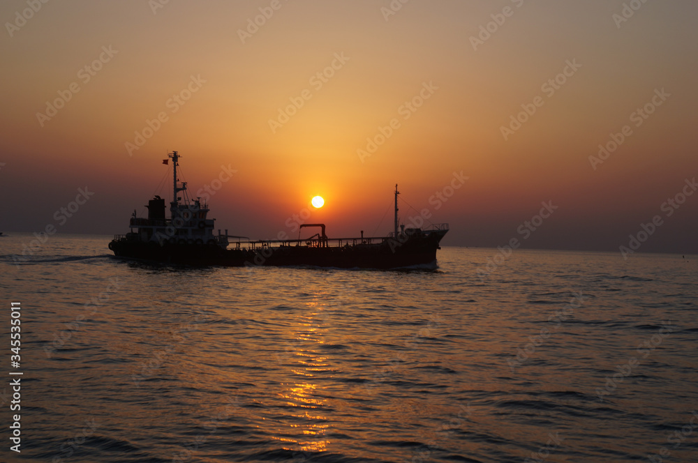 beautiful sunrise and ship on sea 