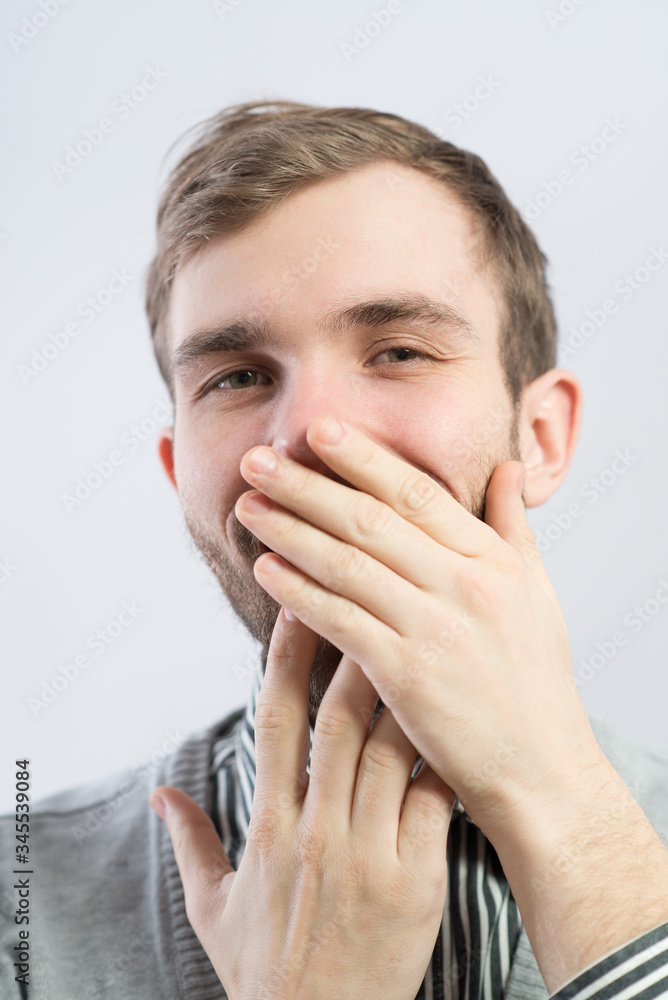 A young man holding back vulgar jokes A young man holding back vulgar jokes