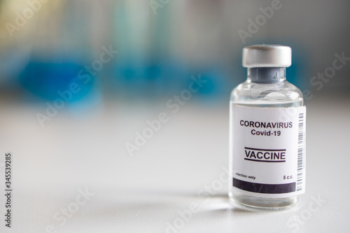 Close-up on Laboratory Tube Virus corona covid 19 vaccine. Scientist research for new novel corona virus immunization drug concept. Coronavirus COVID-19 vaccine vial and injection syringe.