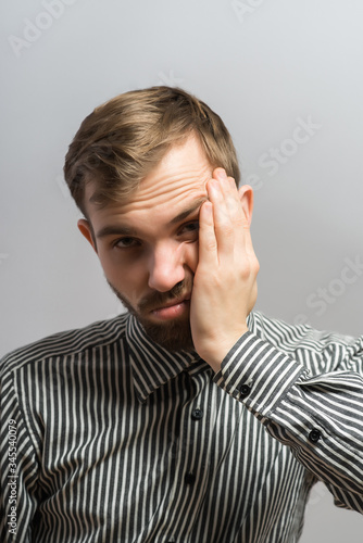 A furious bearded man rising his hands in anger