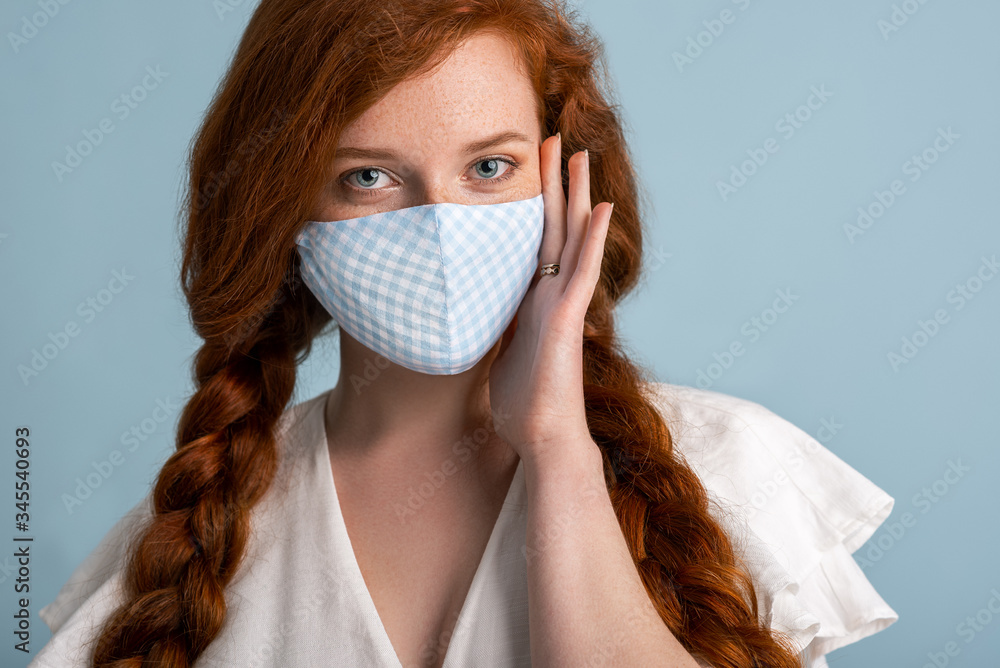 Woman wearing stylish handmade protective face mask. Fashion during quarantine of coronavirus outbreak.  - obrazy, fototapety, plakaty 