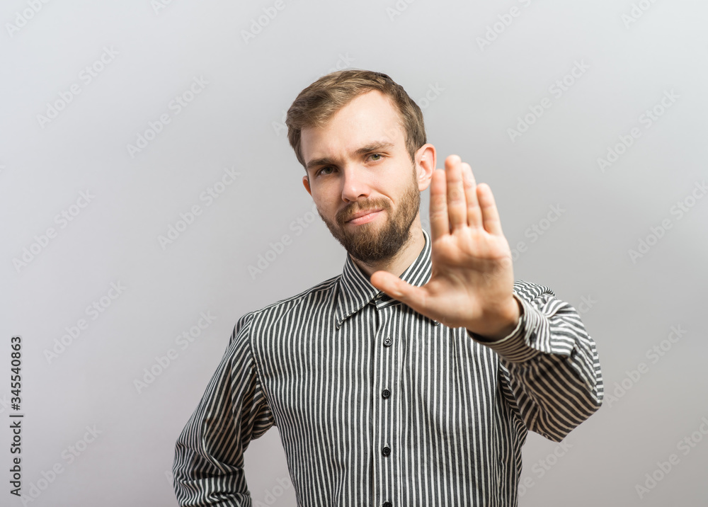Closeup portrait of surprised helpless young man raising hand up to say no stop right there, isolated on white background. Negative emotion facial expression feelings, signs symbols, body language Closeup portrait of surprised helpless young man raising hand up to say no stop right there, isolated on white background. Negative emotion facial expression feelings, signs symbols, body language